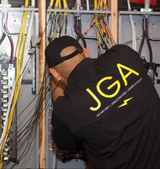 JGA Electric technician working on an electrical panel